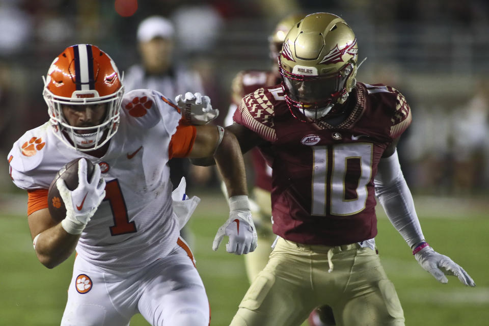 Clemson wide receiver Joseph Ngata (10) runs after a catch as Florida State defensive back Jammie Robinson (10) tries to grab him during the second quarter of an NCAA college football game Saturday, Oct. 15, 2022, in Tallahassee, Fla. (AP Photo/Phil Sears)