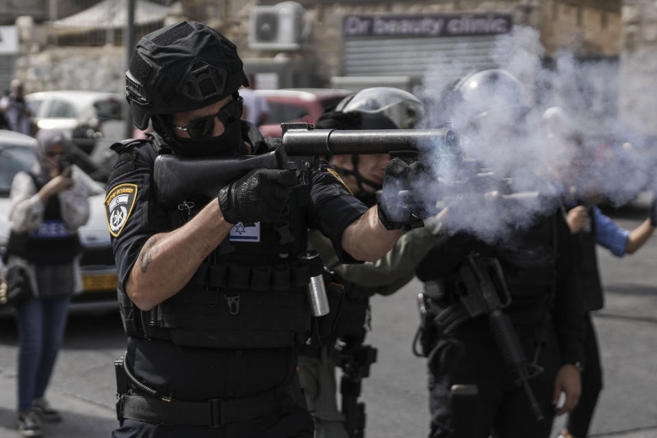 Israeli security forces shoot tear gas canisters towards Palestinians during riots near Jerusalem's Old City, Friday, Oct. 27, 2023. (AP Photo/Mahmoud illean)