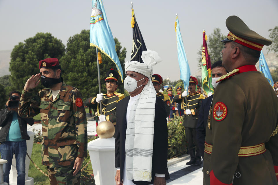 Afghan President Ashraf Ghani sings the national anthem after laying flowers on the Independence Minaret monument during the Independence Day celebrations at the Defense Ministry in Kabul, Afghanistan, Tuesday, Aug. 18, 2020. (AP Photo/Rahmat Gul)