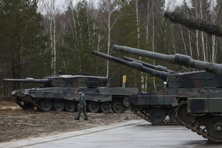 Un soldado polaco camina junto a los tanques Leopard 2 durante un entrenamiento en una base militar y campo de pruebas en Swietoszow, Polonia, el lunes 13 de febrero de 2023. El entrenamiento es parte de la asistencia militar de la Unión Europea a Ucrania