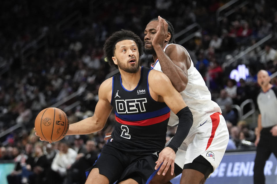 Detroit Pistons guard Cade Cunningham, left, drives on Los Angeles Clippers forward Kawhi Leonard, right, in the first half of an NBA basketball game in Detroit, Friday, Feb. 2, 2024. (AP Photo/Paul Sancya)