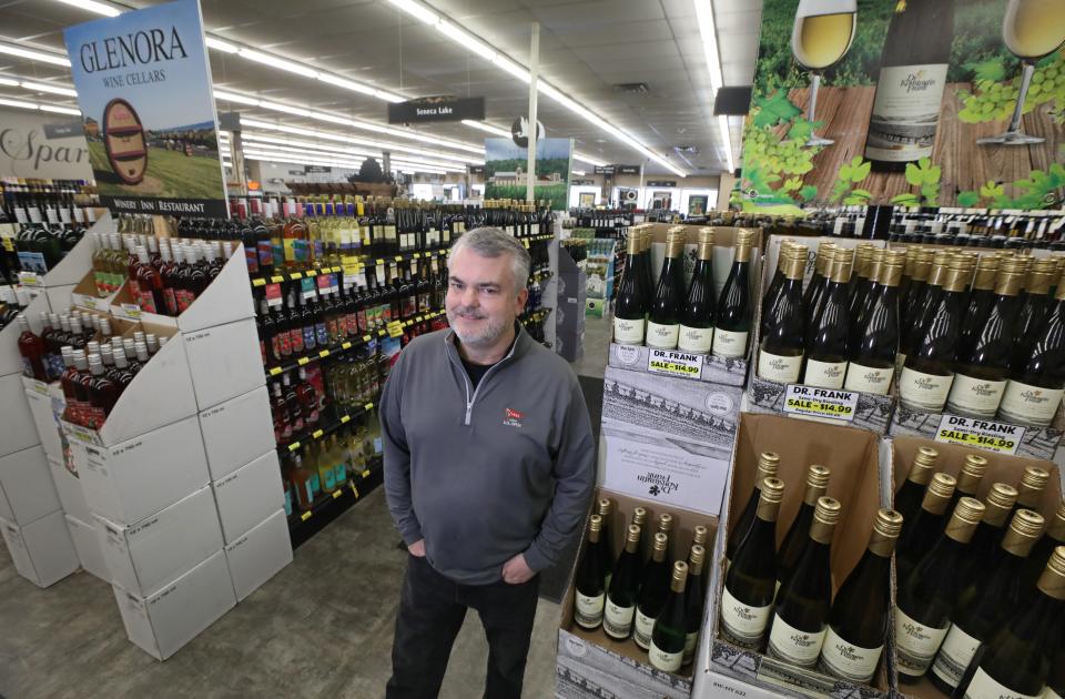 JR Miller, owner, stands surrounded by New York State wines at Ryan's Wine & Spirits in Canandaigua Friday, Feb. 23, 2024.