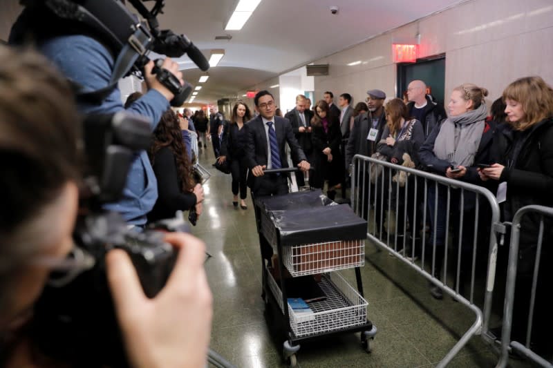 A lawyer pushes a cart of files into the courtroom for the case against film producer Harvey Weinstein at New York Criminal Court during the sexual assault trial in the Manhattan borough of New York City, New York