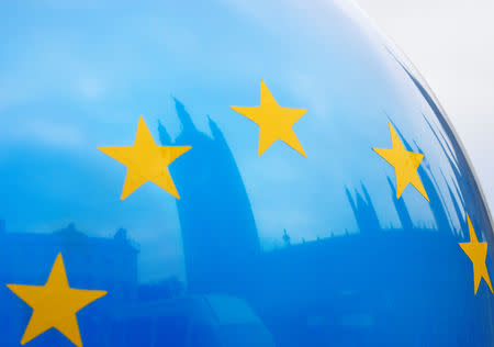 The Houses of Parliament are reflected in an EU flag balloon in London, Britain, December 10, 2018. REUTERS/Toby Melville