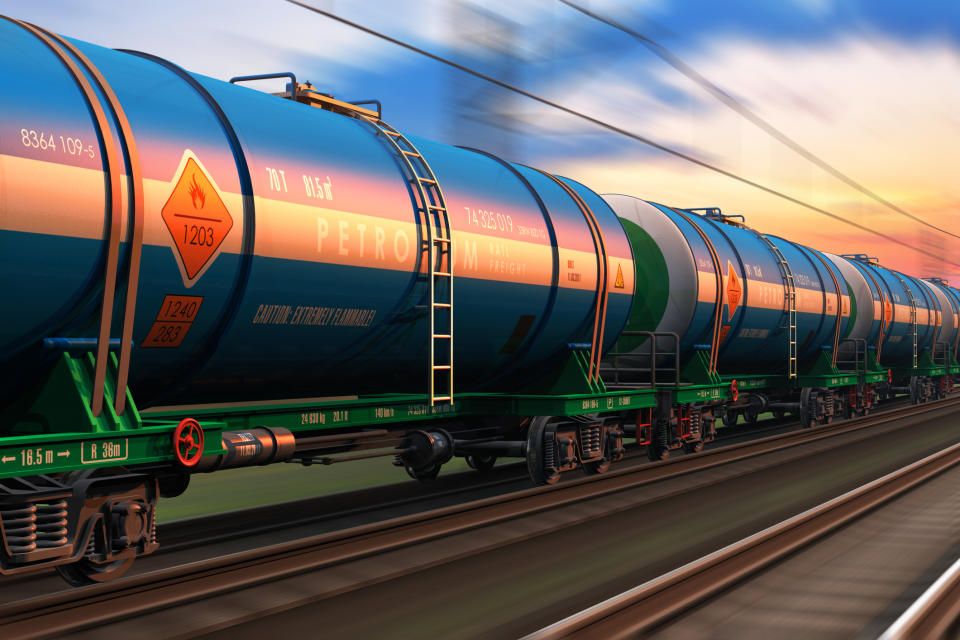 A freight train with petroleum tankers seen at dusk.