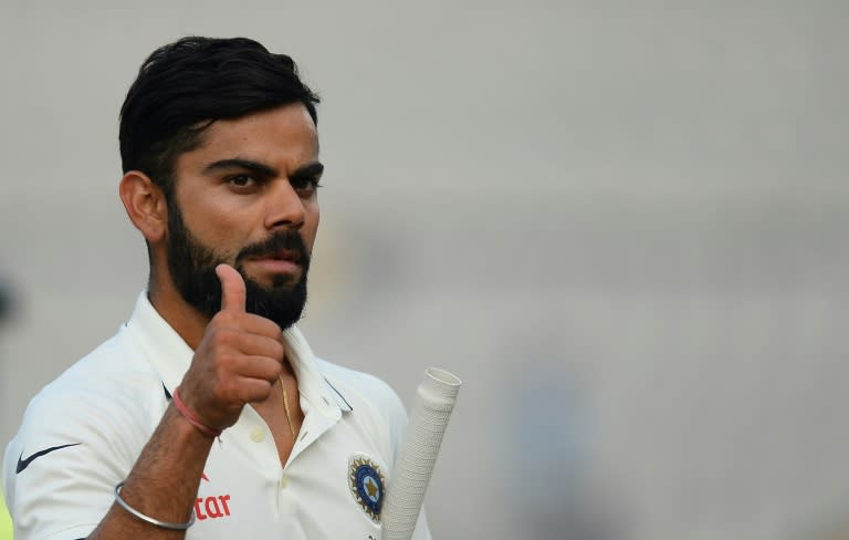 Captain Virat Kohli gestures towards fans after India won the third Test against England in Mohali on November 29, 2016