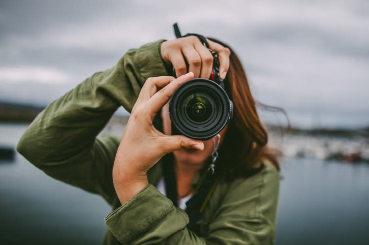 A woman taking a photograph.