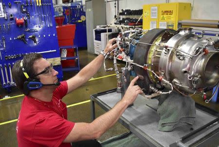 Mechanic Andrew Newingham uses a wireless headset and voice-controlled computer to quickly input details about an auxiliary power unit engine needing repairs at a Honeywell Aerospace service center in Phoenix, Arizona September 6, 2016. REUTERS/Alwyn Scott