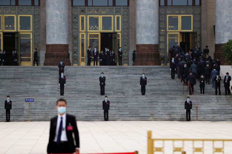 Security personnel stand guard outside the Great Hall of the People before the opening session of CPPCC in Beijing