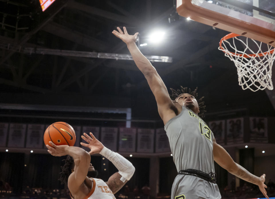 Texas guard Tyrese Hunter, left, puts up the game winning shot at the buzzer against Baylor guard Langston Love, right, to win an NCAA college basketball game, Saturday, Jan. 20, 2024, in Austin, Texas. Texas won 75-73. (AP Photo/Michael Thomas)