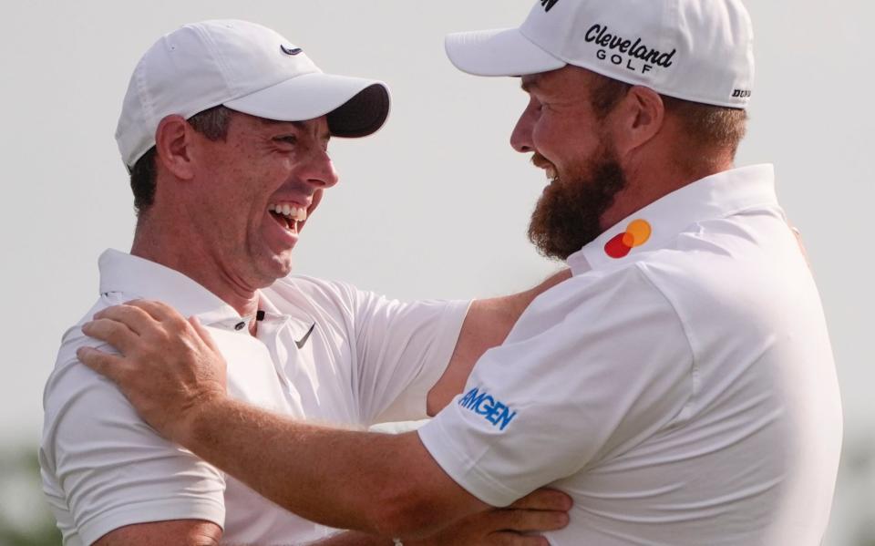 Shane Lowry, of Ireland, right, embraces his teammate Rory McIlroy, of Northern Ireland, after winning the PGA Zurich Classic golf tournament at TPC Louisiana in Avondale