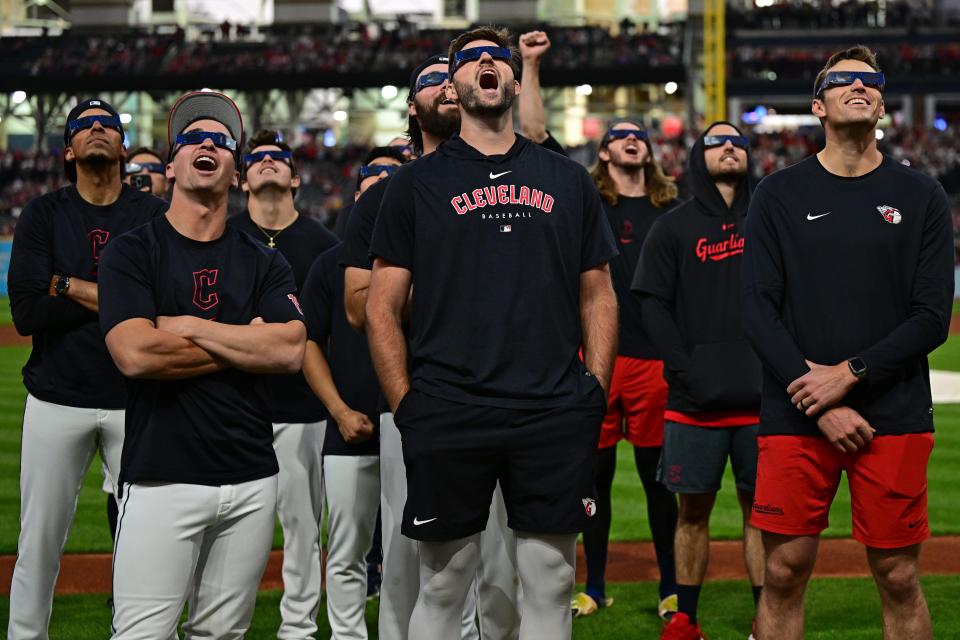 April 8: Players for the Cleveland Guardians watch a total solar eclipse before a game against the Chicago White Sox at Progressive Field.