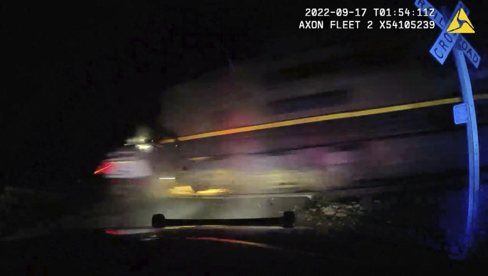 FILE - This screen grab from dash camera video provided by the Fort Lupton Police Department shows a freight train hitting a parked police car with a suspect inside, Sept. 16, 2022, in Fort Lupton, Colo. A former Fort Lupton Police Officer, Jordan Steinke, was sentenced to 30 months on supervised probation on Friday, Sept. 15, 2023, for placing the handcuffed suspect in the car on the tracks. The collision seriously injured 21-year-old Yareni Rios-Gonzalez. The date/time stamp shown on the video is incorrect. (Fort Lupton Police Department via AP, File)