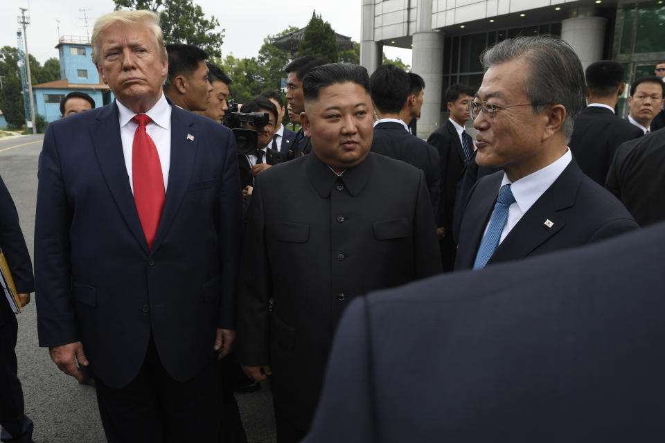 President Donald Trump, left, North Korean leader Kim Jong Un, center, and South Korean President Moon Jae-in, right, walk together at the border village of Panmunjom in Demilitarized Zone, South Korea, Sunday, June 30, 2019. (AP Photo/Susan Walsh)