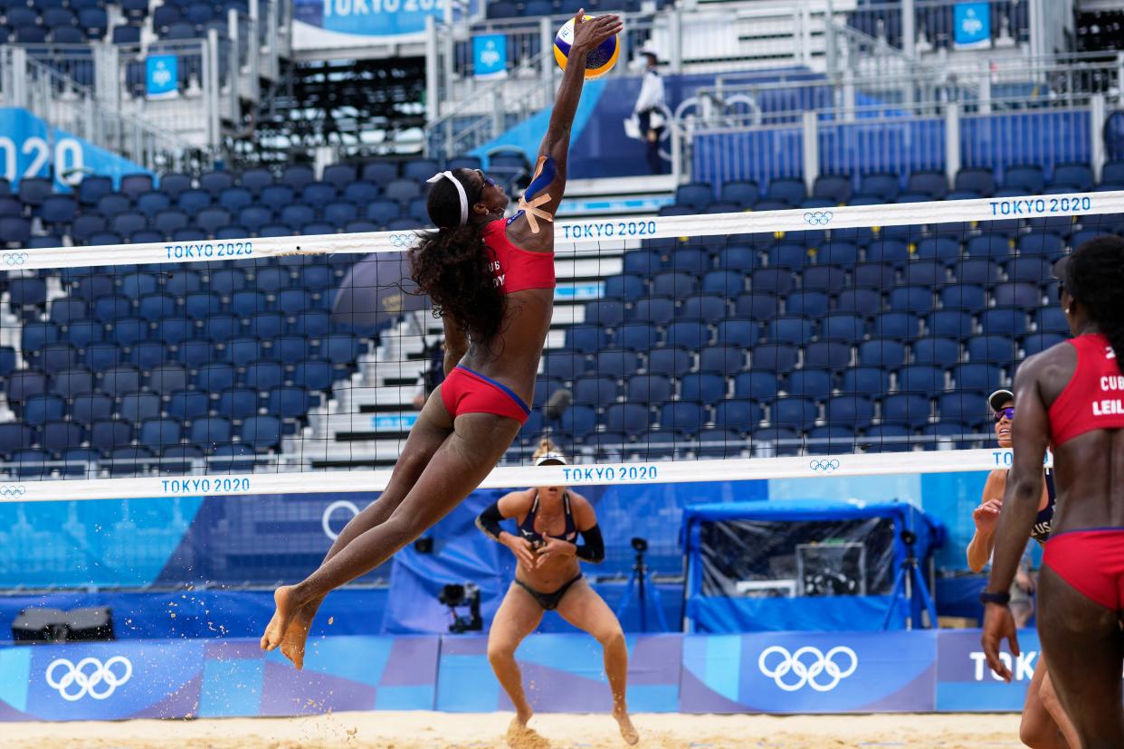 Lidianny Echevarria Benitez, of Cuba, jumps high for the ball during a women's beach volleyball match against the United States at the 2020 Summer Olympics, Monday, Aug. 2, 2021, in Tokyo, Japan.