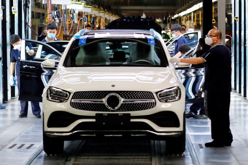 FILE PHOTO: Employees wearing face masks work at a plant owned by the Daimler-BAIC joint venture’s Beijing Benz Automotive Co