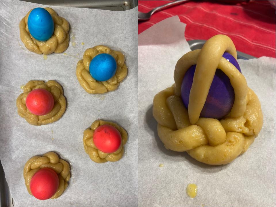 Dough wreaths with a colorful egg on each one next to one with a dough cross draped over the egg.