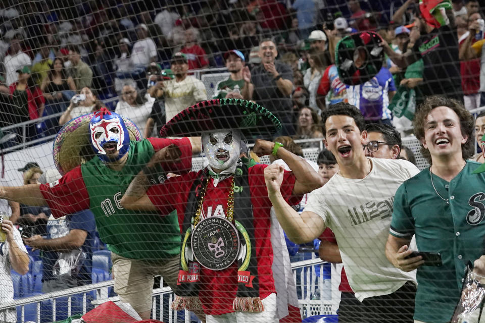 FILE -Mexico fans celebrate the 5-4 win over Puerto Rico during a World Baseball Classic game, Friday, March 17, 2023, in Miami. Major League Baseball is heading south of the border again to play a regular season series. After previous stops in Monterrey, Mexico City will be the host this time, and the timing seems perfect.(AP Photo/Marta Lavandier, File)