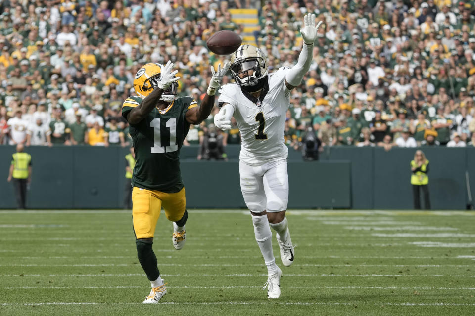 Green Bay Packers wide receiver Jayden Reed (11) pulls in a first down catch against New Orleans Saints cornerback Alontae Taylor (1) during the second half of an NFL football game Sunday, Sept. 24, 2023, in Green Bay, Wis. (AP Photo/Morry Gash)