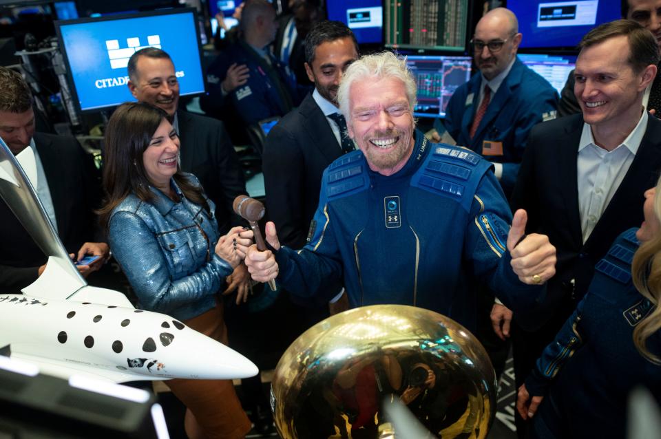 Richard Branson, Founder of Virgin Galactic (C) poses next to George T. Whitesides (R), CEO of Virgin Galactic Holdings after ringing the First Trade Bell to commemorate the company's first day of trading on the New York Stock Exchange (NYSE) on October 28, 2019 in New York City. (Photo by Johannes EISELE / AFP) (Photo by JOHANNES EISELE/AFP via Getty Images)