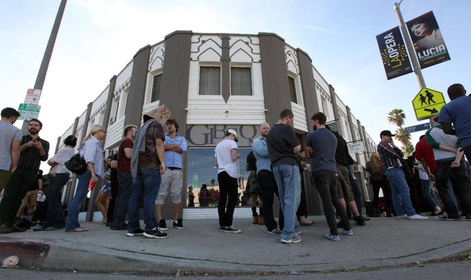 Visitors waiting for more than 2 hours form a line around the corner to the Stephen Cohen Gallery prior to entering for an exhibition called "#IAMSORRY," by actor Shia LaBeouf in Los Angeles on Wednesday, Feb. 12, 2014. Seated at a small table, wearing a disheveled tuxedo and the paper bag with some eye holes cut out and the words "I AM NOT FAMOUS ANYMORE" scrawled in black ink across it, LaBeouf began his planned seven-hour, seven-day stint inside the small gallery on Tuesday, Feb. 11, 2014. (AP Photo/Richard Vogel)