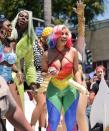 <p>Cardi B turned heads in a stunning sequined rainbow patterned jumpsuit. She kept her Pride outfit simple with gold jewelry, but her main accessory was her rainbow-tipped, platinum-blond hairstyle. She performed in bedazzled pink heels, but quickly switched to a comfier set of Christian Dior slides as she walked around offering Whipshots to the crowd. </p>