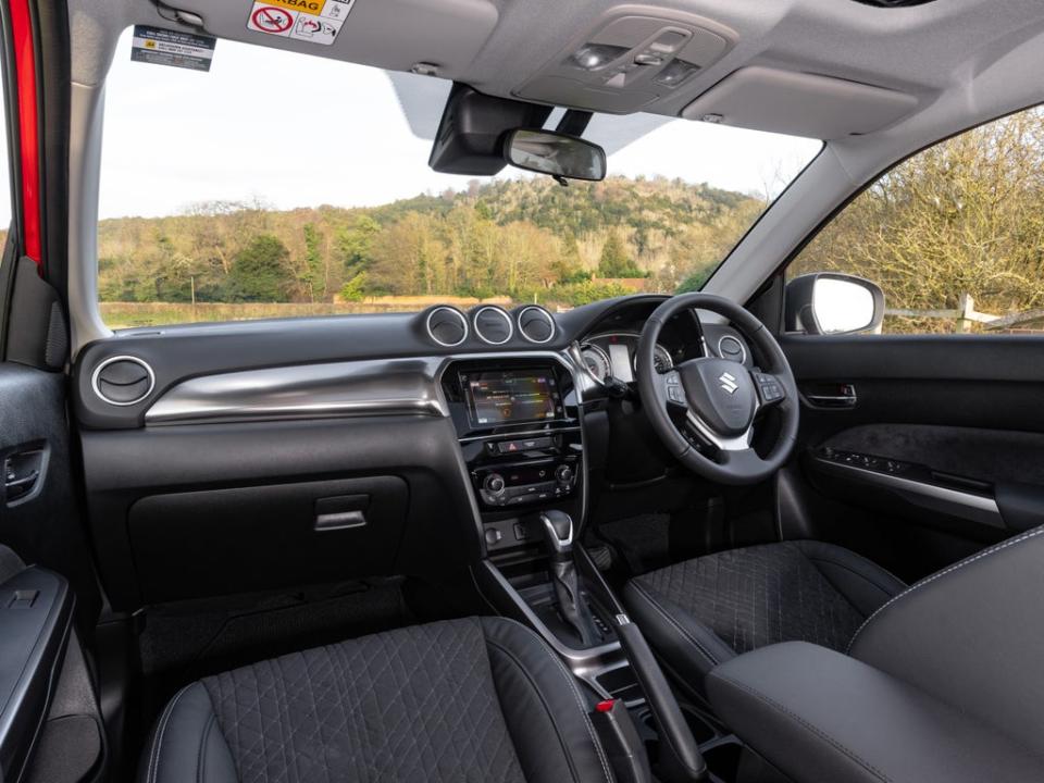 The cabin features some rather old-school plastics and touchscreen graphics (Suzuki)