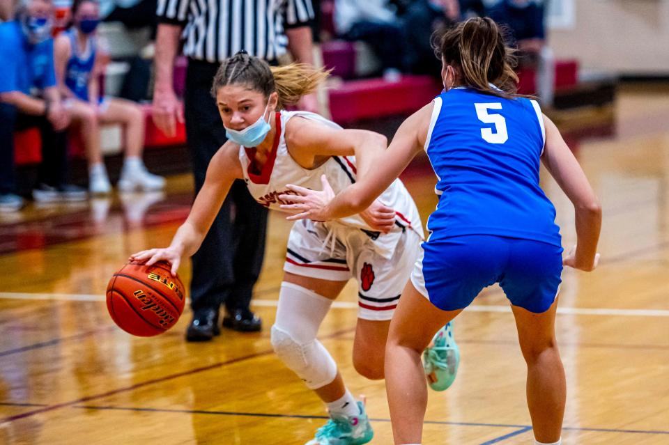 Old Rochester's Tess Adams drives around Fairhaven's Maya Medeiros.