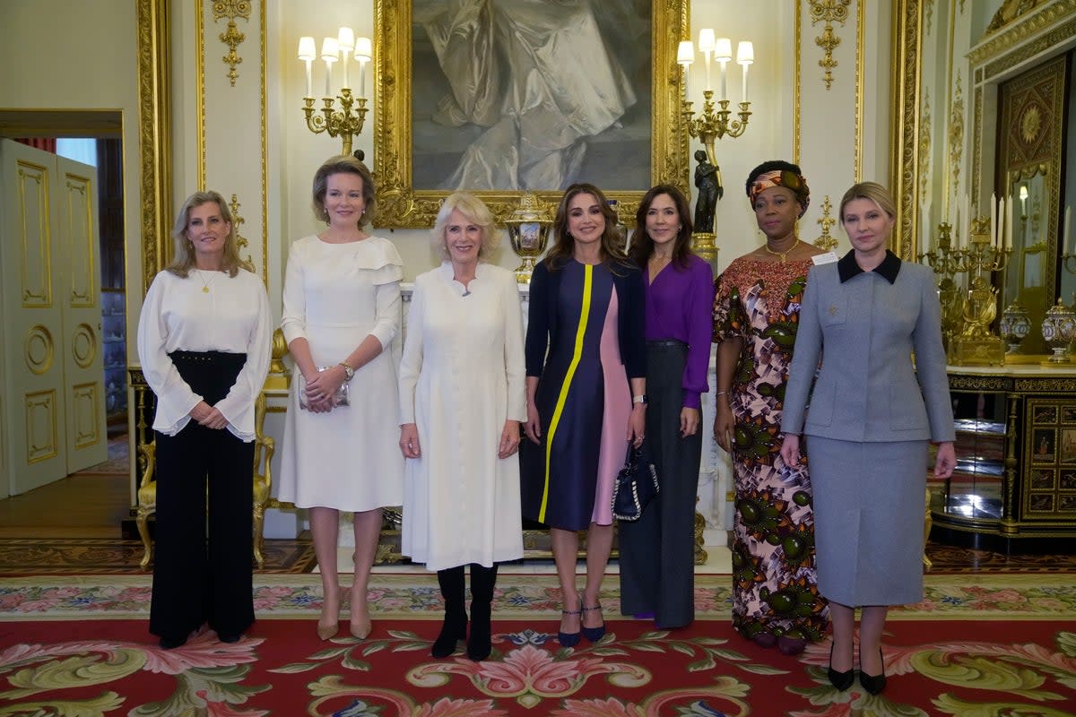 From left, Britain's Sophie, the Countess of Wessex, Queen Mathilde of Belgium, Camilla, The Queen Consort, Queen Rania of Jordan, Danish Crown Princess Mary, the first lady of Sierra Leone Fatima Maada Bio, and the first lady of Ukraine Olena Zelenska (AP)