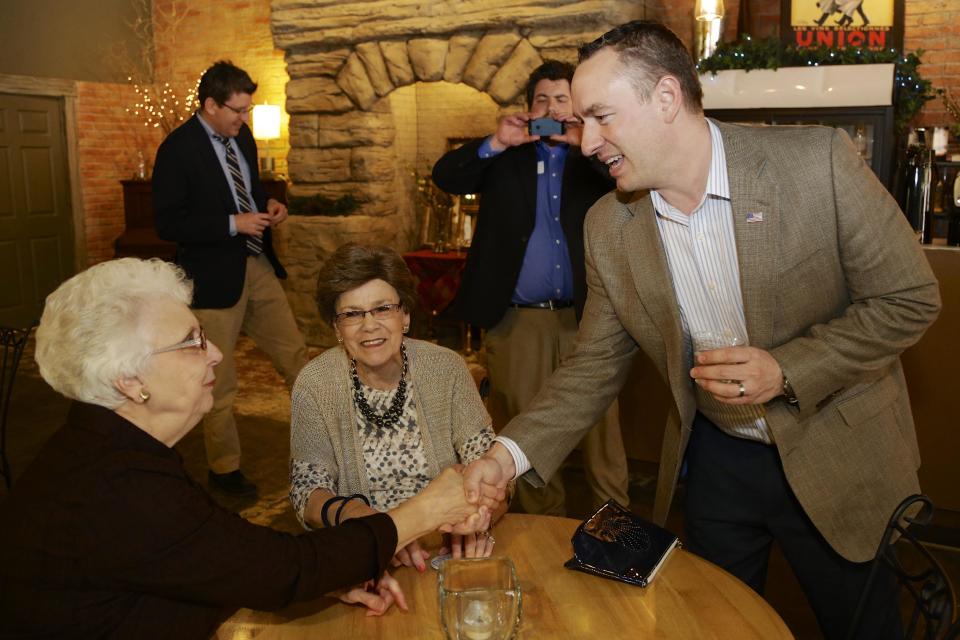 In this March 13, 2014 photo Nebraska Senate candidate Shane Osborn, backed by the Republican Party, campaigns in in Fairbury, Neb. The heavy outside influence in Nebraska's race between Osborn and tea party-backed Ben Sasse is a change from previous elections, when party leaders largely left the choice to voters. But the ugly jousting in Congress between party powerbrokers and right-wing insurgents, and the party’s losses in 2012, ended that practice. (AP Photo/Nati Harnik)