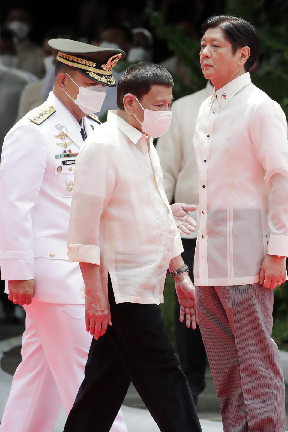 Incoming Philippine president Ferdinand Marcos Jr., right, and outgoing President Rodrigo Duterte, center, attend Marcos' inauguration ceremony at the Malacanang Presidential Palace grounds in Manila, Philippines, Thursday, June 30, 2022. Marcos, the son of the late president Ferdinand Marcos has been sworn in as the Philippine president. (Francis R. Malasig/Pool Photo via AP)