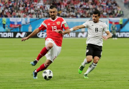 Soccer Football - World Cup - Group A - Russia vs Egypt - Saint Petersburg Stadium, Saint Petersburg, Russia - June 19, 2018 Egypt's Tarek Hamed in action with Russia's Aleksandr Samedov REUTERS/Henry Romero