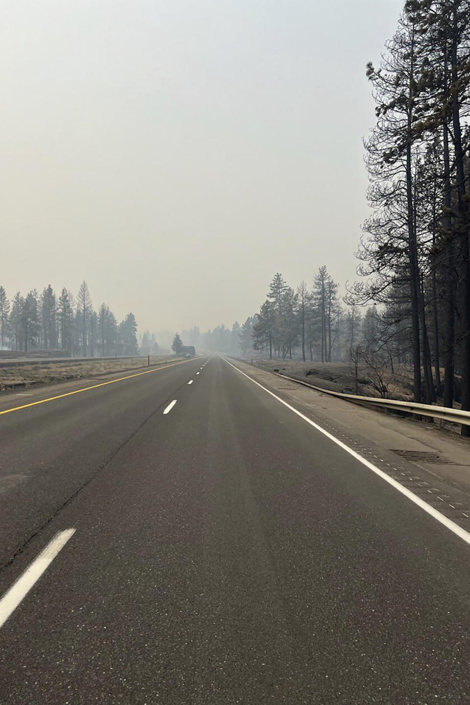 FILE - This photo provided by WSDOT East (Washington State of Transportation) smoke from wildfires fill the sky at Salnave/SR 902 interchange in Spokane County, Wash., on Saturday, Aug. 19, 2023. Authorities say a second person has died in wildfires in eastern Washington state that sparked Friday, burning hundreds of structures and closing a section of a major interstate. Fire officials said Monday, Aug. 21, a body was found in the area of the Oregon fire north of Spokane on Sunday. (WSDOT East via AP, File)