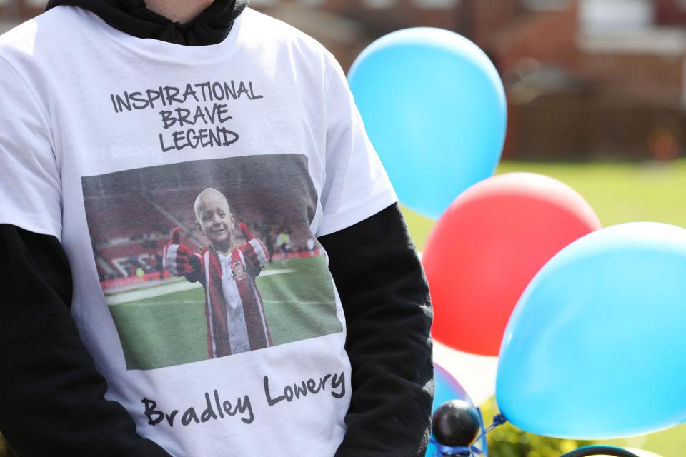 <p>People line the route of the funeral procession with decorations ahead of the funeral of Bradley Lowery, the six-year-old football mascot whose cancer battle captured hearts around the world </p>