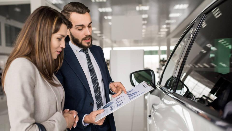 car agent with customer in showroom