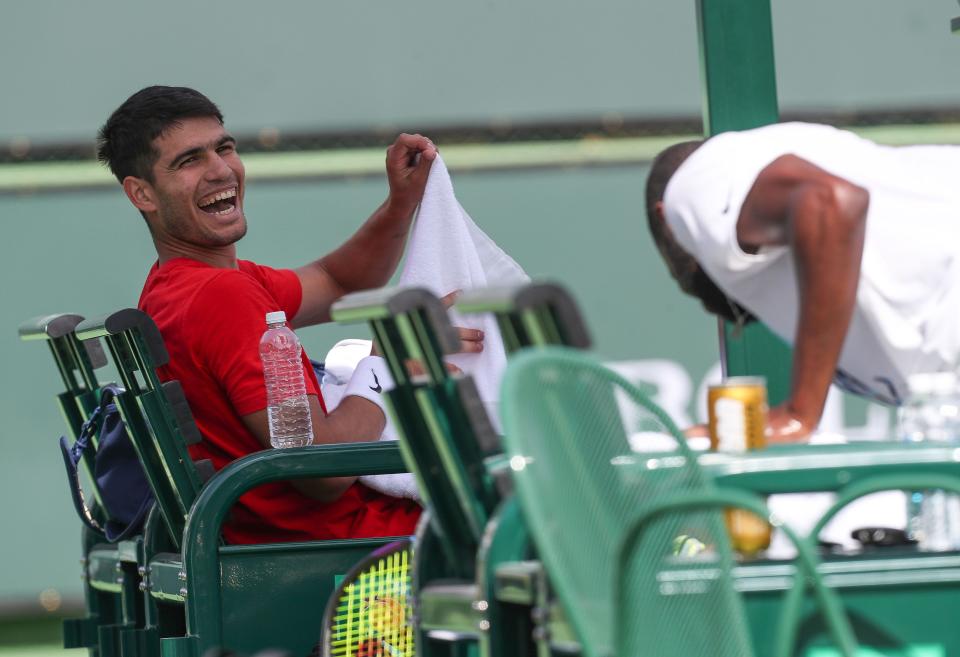 Carlos Alcaraz, left, and Frances Tiafoe share a laugh while practicing at the BNP Paribas Open in Indian Wells, Calif., March 8, 2023. 