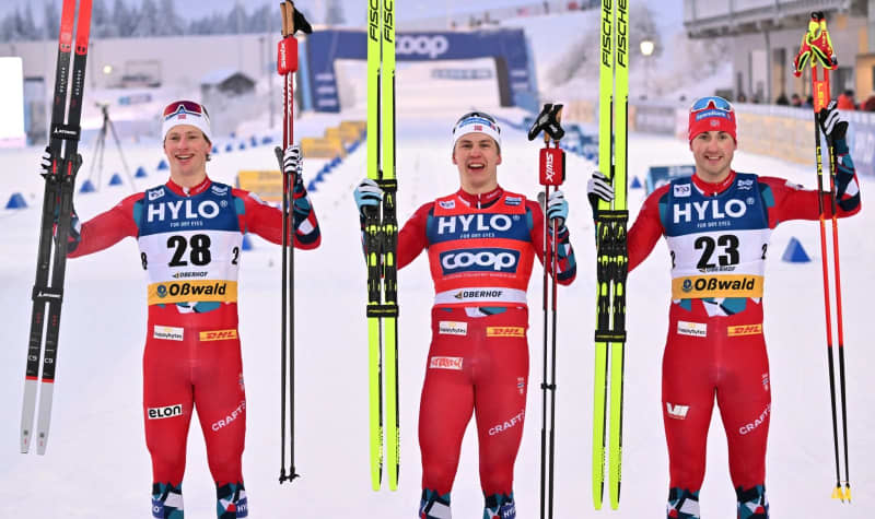 (L-R) Norwegian cross-country skiers Ansgar Evensen, winner Erik Valnes and Even Northug celebrate at the finish line after the final of the cross-country skiing World Cup in the classic sprint discipline. Martin Schutt/dpa