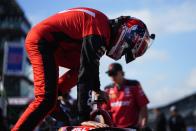 Will Power, of Australia, climbs into his car during a practice session for the IndyCar Grand Prix auto race at Indianapolis Motor Speedway, Friday, May 10, 2024, in Indianapolis. (AP Photo/Darron Cummings)