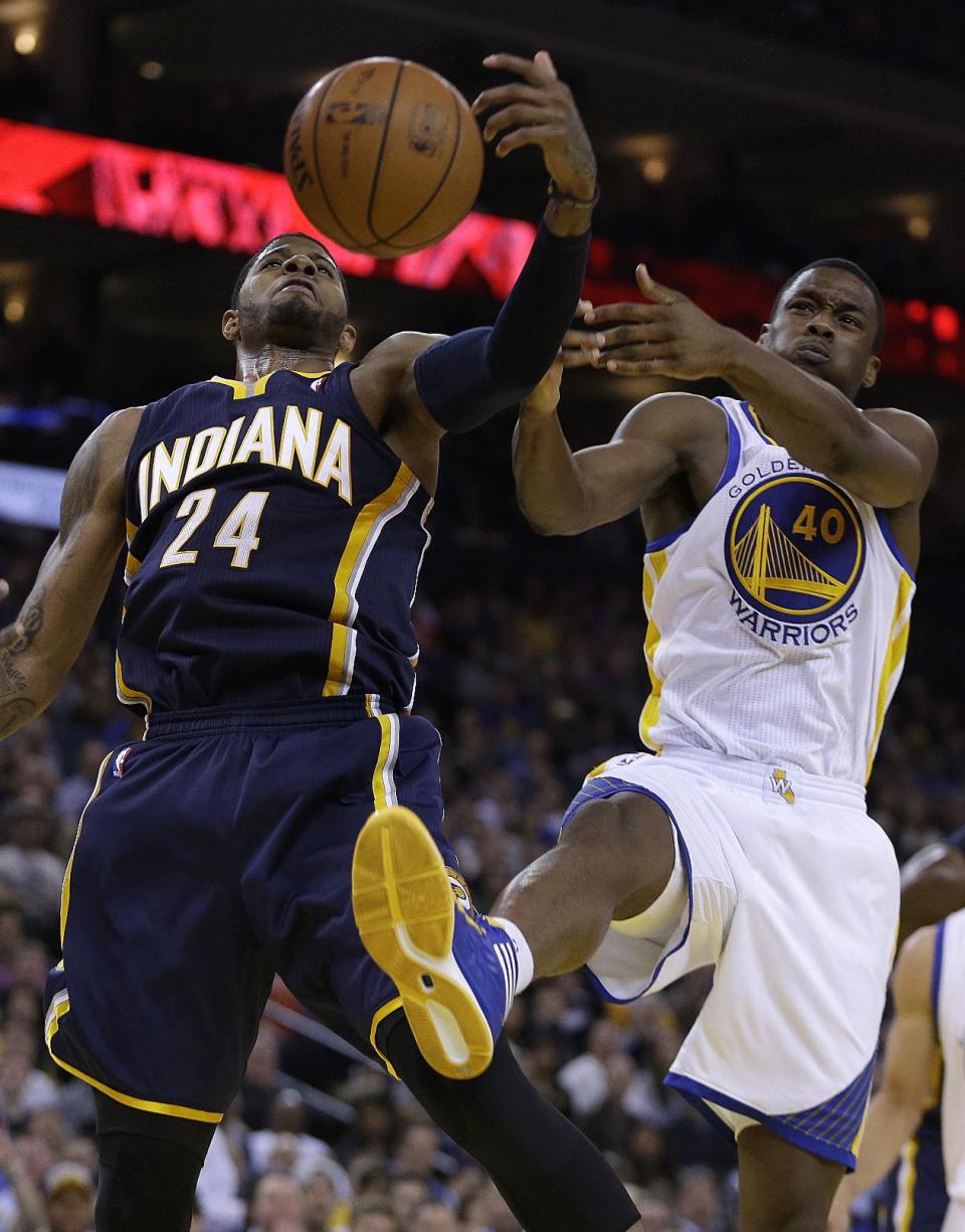 Indiana Pacers' Paul George, left, and Golden State Warriors' Harrison Barnes fight for a rebound during the second half of an NBA basketball game Monday, Jan. 20, 2014, in Oakland, Calif. (AP Photo/Ben Margot)