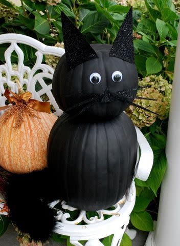 Paint your pumpkins black and create a cat or bat design really easily with some black card and goggly eyes.