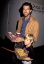 <p>Pierce Brosnan loads up on movie theater snacks with his son Sean during the premiere of Teenage Mutant Ninja Turtles in 1990. </p>