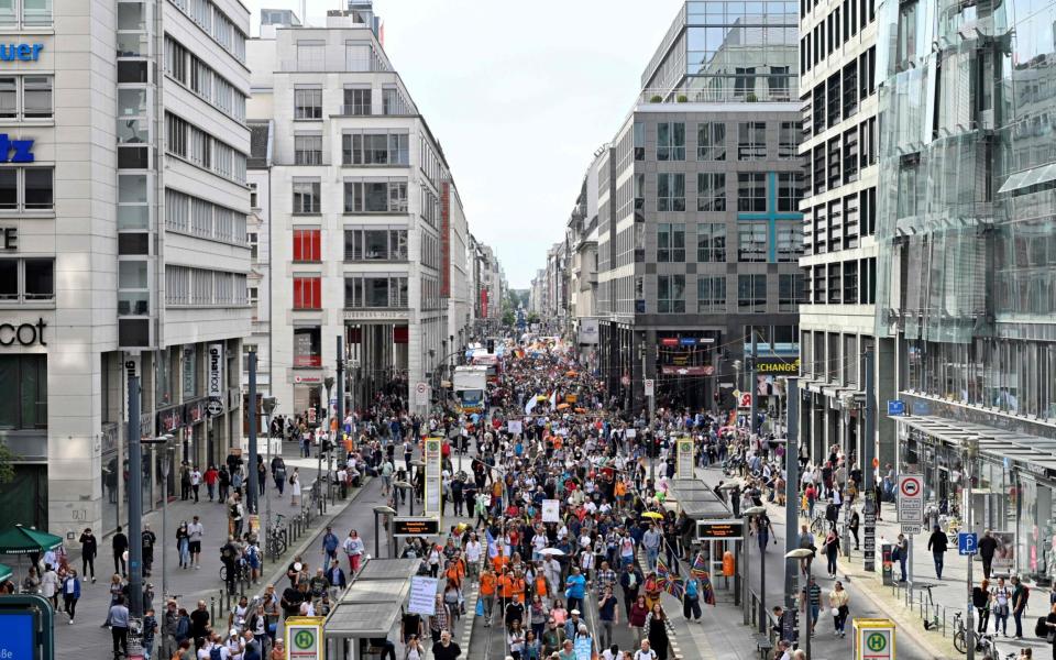 People take part in a demonstration  - AFP