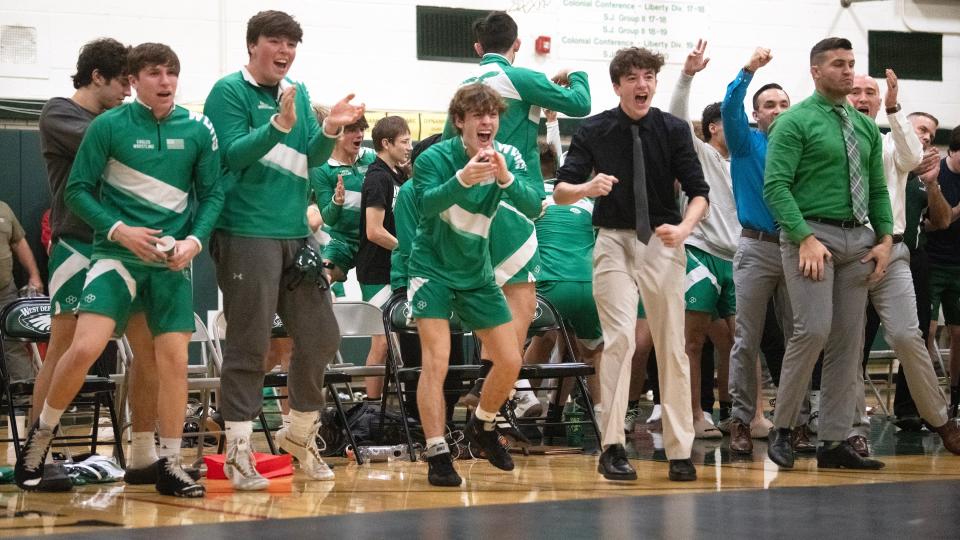 Members of the West Deptford High School wrestling team celebrate as West Deptford's Andrew Tighe pins Paulsboro's Jared Hazel during the 285 lb. bout of the wrestling meet held at West Deptford High School on Thursday, January 4, 2024.