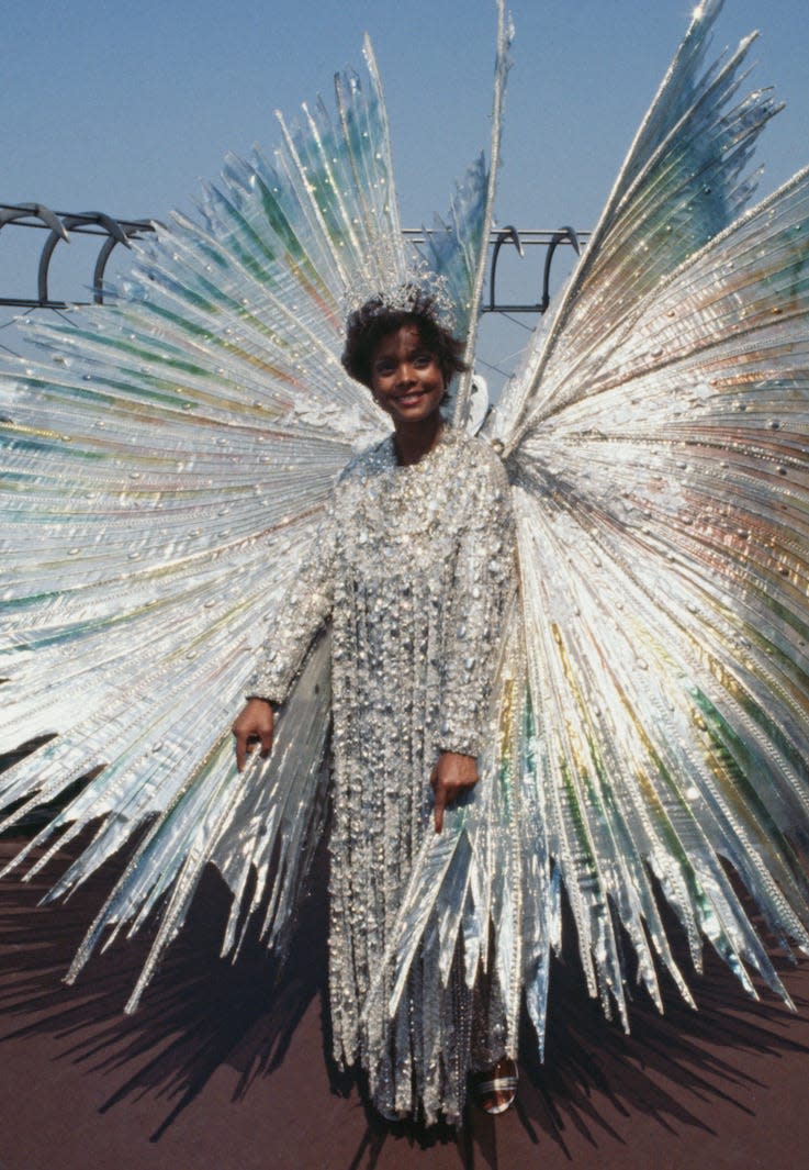 Miss Universe Janelle Commissiong posing in a silver costume on top of the Empire State Building in New York, July 21st 1977. Janelle, 24, of Trinidad was crowned Miss Universe in Santo Domingo on July 16th. Her winged dress is made of iridescent silk and was inspired by the hummingbird, Trinidad's national bird.