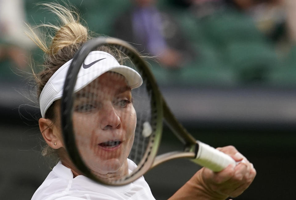 FILE - Romania's Simona Halep returns to Spain's Paula Badosa in a women's singles fourth round match on day eight of the Wimbledon tennis championships in London, Monday, July 4, 2022. Former No. 1-ranked player Simona Halep was provisionally suspended by the International Tennis Integrity Agency after failing a drug test during the U.S. Open last month. The ITIA announced the suspension Friday, Oct. 21, 2022, for Halep, a two-time Grand Slam champion who is currently No. 9 in the WTA rankings.(AP Photo/Alberto Pezzali, File)