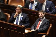 Israeli right wing Knesset member Itamar Ben Gvir, left, and Bezalel Smotrich look on during the swearing-in ceremony for Israeli lawmakers at the Knesset, Israel's parliament, in Jerusalem, Tuesday, Nov. 15, 2022. Israeli lawmakers were sworn in at the Knesset, on Tuesday, following national elections earlier this month. (Abir Sultan/Pool Photo via AP)