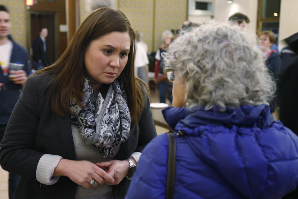 FILE—In this file photo from Feb. 18, 2020, Nikki Foster, Democratic candidate for Ohio's first congressional district, greets a woman following a question and answer session held by the Bold New Democracy Work Group, in Cincinnati. In Ohio, candidates such as Democratic congressional hopefuls Foster and Kate Schroder nearly emptied their campaign coffers in the closing days before March 17, and now are focusing on social media and phone banks to keep up their campaigns while awaiting clarity on when the primary will end amid the coronavirus stay-home orders. (AP Photo/Gary Landers, File)