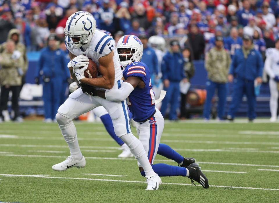 Colts receiver Michael Pittman Jr., drags Bills TreDavious White for extra yards after a catch. 