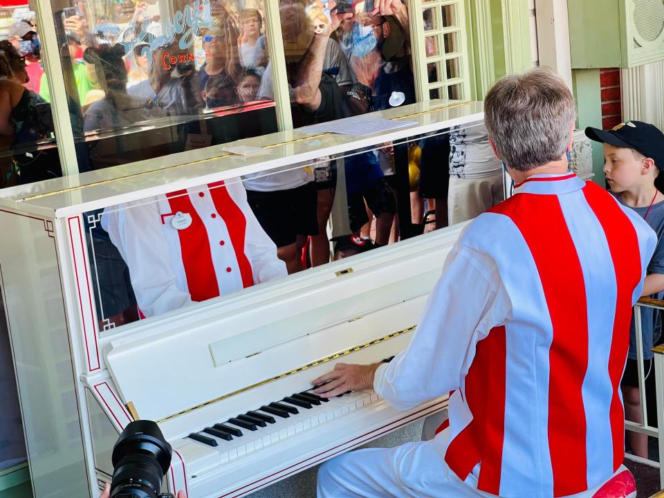 pianist at casey's corner magic kingdom during disney world 50th anniversary