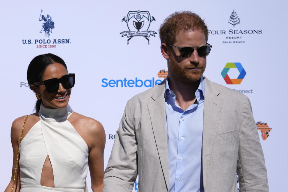 Britain's Prince Harry, right, and wife Meghan Markle, Duchess of Sussex, arrive for the 2024 Royal Salute Polo Challenge to Benefit Sentebale, Friday, April 12, 2024, in Wellington, Fla. Prince Harry, co-founding patron of the Sentebale charity, will play on the Royal Salute Sentebale Team. (AP Photo/Rebecca Blackwell)